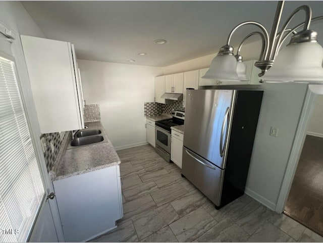 kitchen with sink, white cabinetry, stainless steel appliances, and tasteful backsplash