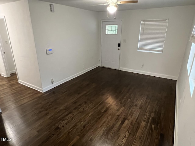 entryway with dark hardwood / wood-style flooring and ceiling fan