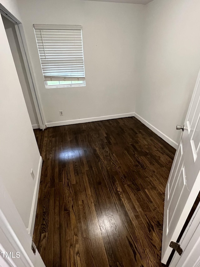 spare room with dark hardwood / wood-style flooring