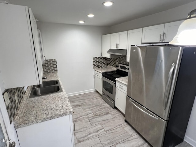 kitchen featuring white cabinets, sink, appliances with stainless steel finishes, and tasteful backsplash