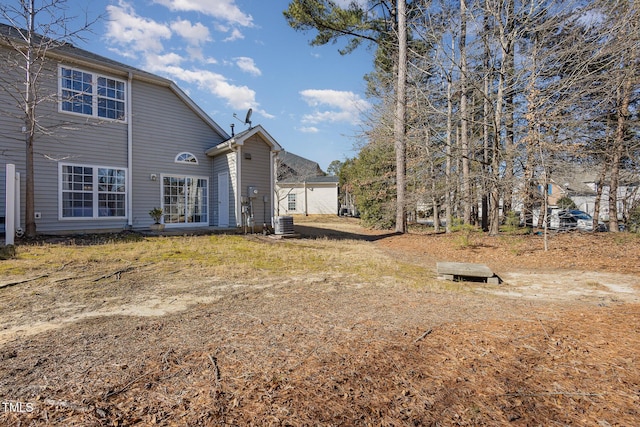 rear view of house with central AC unit