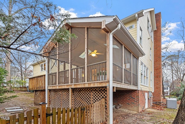 view of side of property featuring central AC unit and a sunroom