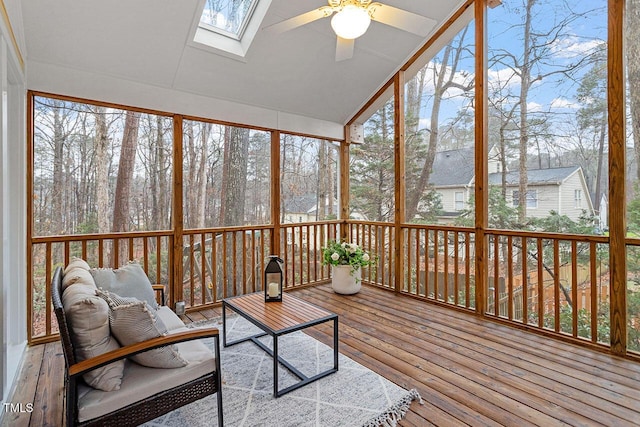 sunroom / solarium featuring ceiling fan and lofted ceiling with skylight