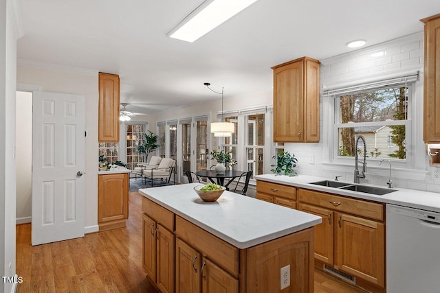 kitchen with sink, decorative light fixtures, a center island, dishwasher, and ceiling fan