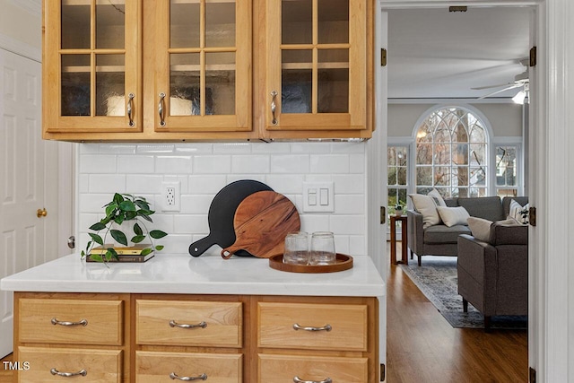 kitchen with ceiling fan, backsplash, and dark wood-type flooring