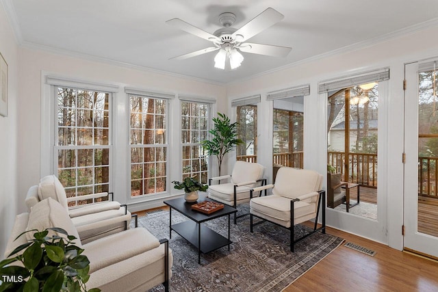 sunroom / solarium featuring ceiling fan and a wealth of natural light