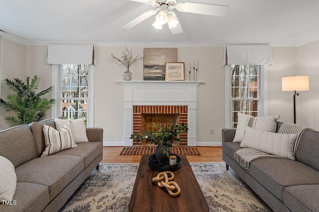 living room with ornamental molding, a brick fireplace, and wood-type flooring