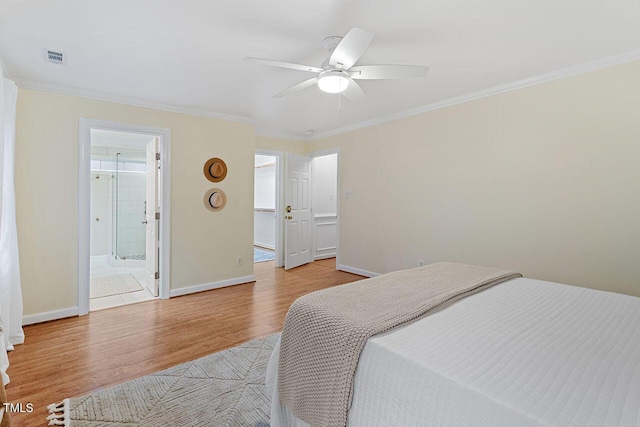 bedroom with ceiling fan, crown molding, light hardwood / wood-style flooring, and ensuite bath