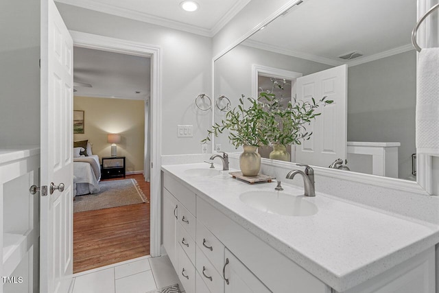 bathroom featuring ornamental molding, tile patterned flooring, and vanity