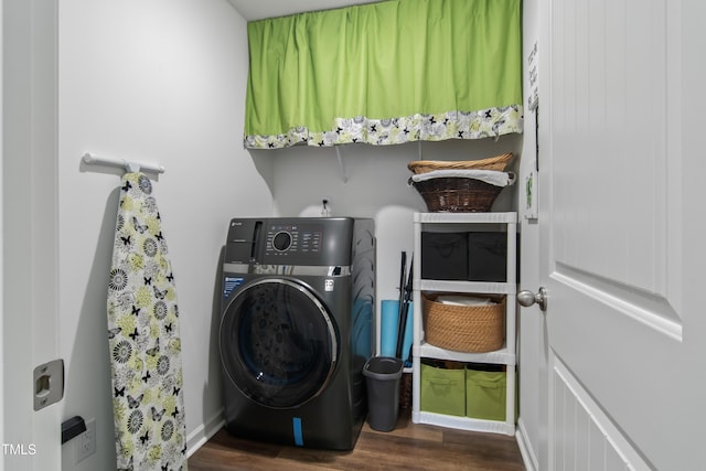 clothes washing area featuring washer / dryer and dark wood-type flooring