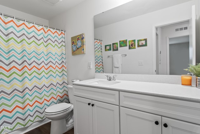 bathroom with a shower with shower curtain, vanity, and toilet