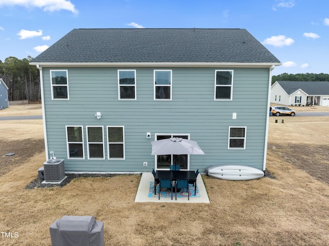 rear view of house featuring a lawn, a patio area, and central AC unit