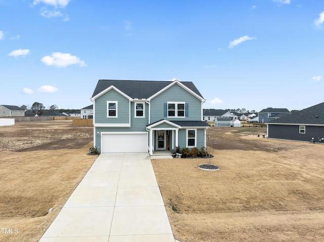 view of property with covered porch, a front yard, and a garage