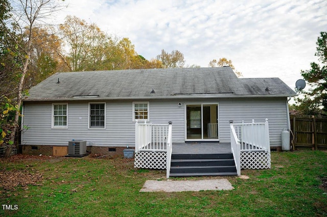 back of house featuring a deck, central AC unit, and a lawn