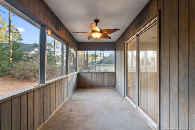 unfurnished sunroom featuring plenty of natural light and ceiling fan