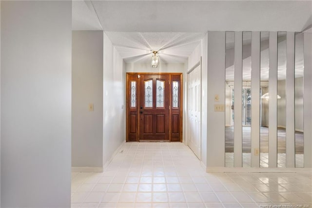 foyer entrance with a textured ceiling