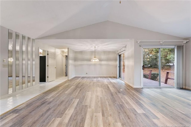 unfurnished living room featuring light hardwood / wood-style floors and lofted ceiling