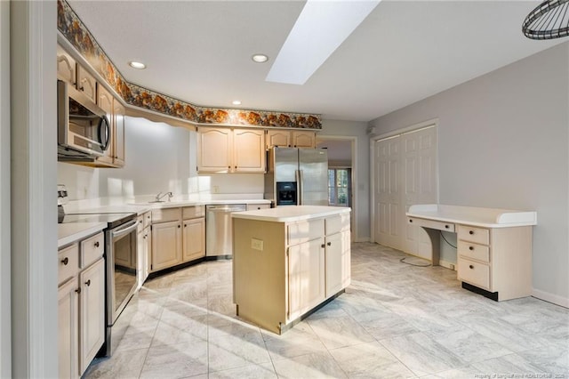 kitchen with a skylight, a center island, stainless steel appliances, and sink