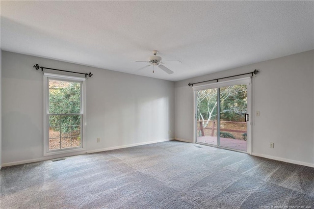 unfurnished room with carpet flooring, ceiling fan, and a healthy amount of sunlight