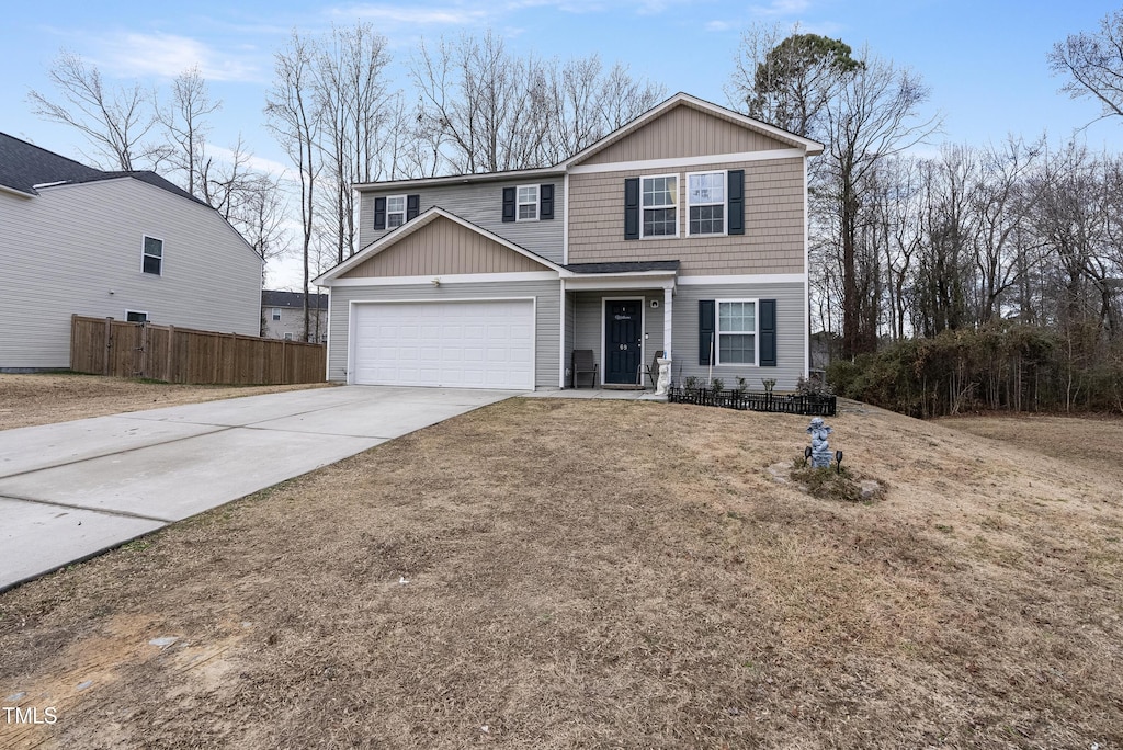 view of property with a garage and a front lawn