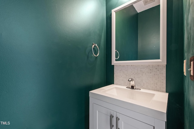 bathroom featuring decorative backsplash and vanity