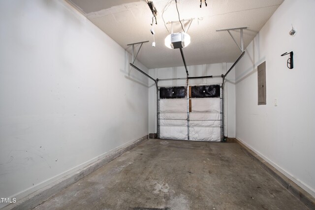 garage featuring a garage door opener, baseboards, and electric panel