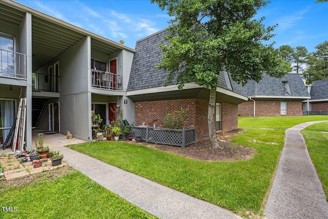 view of side of home with a lawn