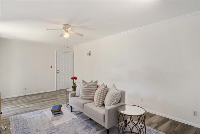 living room featuring wood-type flooring, ceiling fan, and crown molding