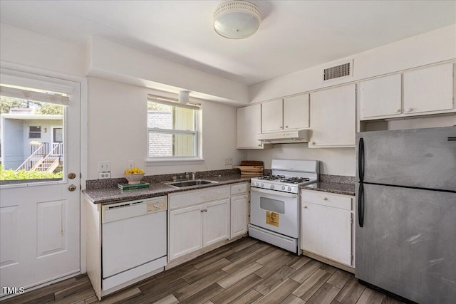 kitchen with white cabinets, white appliances, sink, and dark wood-type flooring