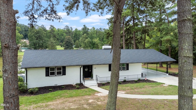 single story home with a front lawn and a carport