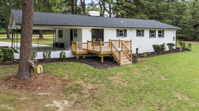 back of house with a lawn and a wooden deck