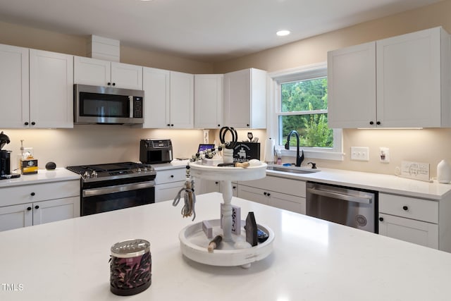 kitchen featuring white cabinetry, sink, and appliances with stainless steel finishes