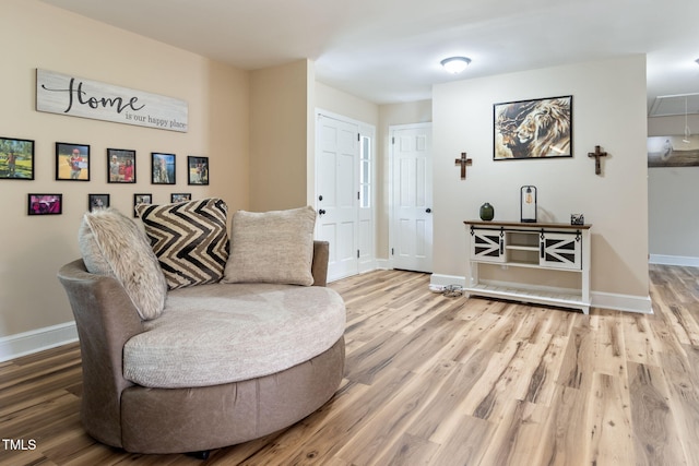 sitting room with hardwood / wood-style flooring