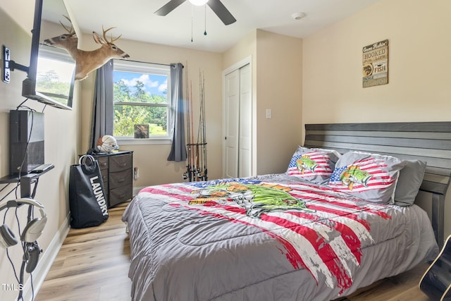 bedroom featuring ceiling fan, light wood-type flooring, and a closet