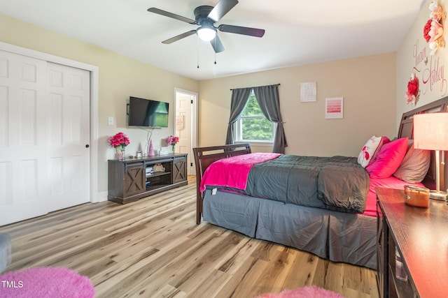 bedroom featuring ceiling fan, a closet, and light wood-type flooring