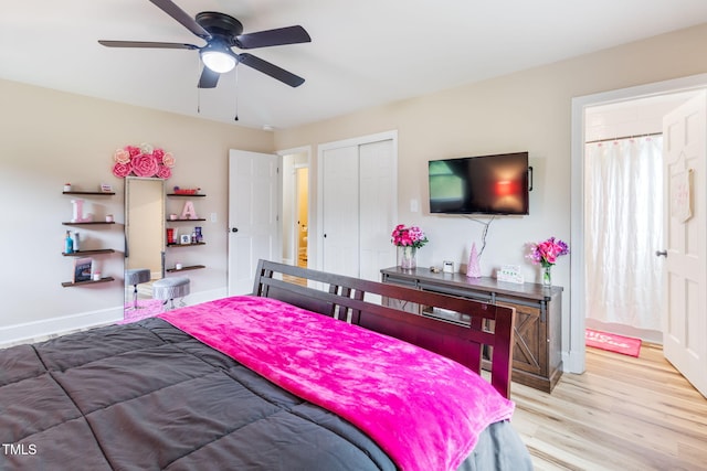 bedroom with ceiling fan, a closet, and light hardwood / wood-style floors