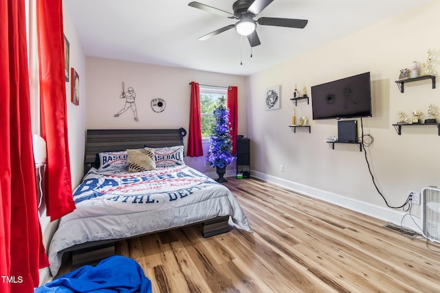 bedroom with ceiling fan and light hardwood / wood-style floors