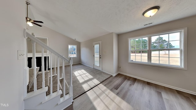 entrance foyer featuring light hardwood / wood-style floors, plenty of natural light, ceiling fan, and lofted ceiling