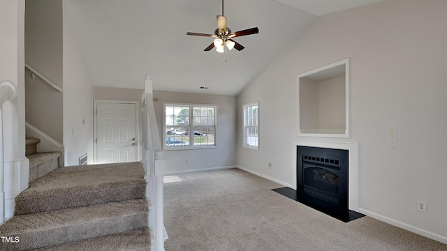 stairway with carpet flooring, ceiling fan, and lofted ceiling