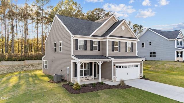 view of front facade featuring a garage, a front lawn, and central AC unit