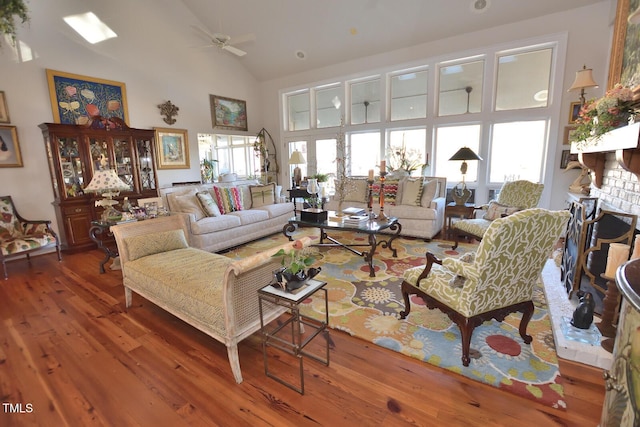 living room featuring ceiling fan, hardwood / wood-style floors, and high vaulted ceiling