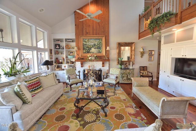 living room featuring hardwood / wood-style flooring, high vaulted ceiling, and ceiling fan