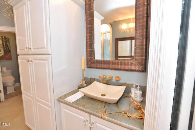 bathroom featuring tile patterned floors, vanity, and toilet