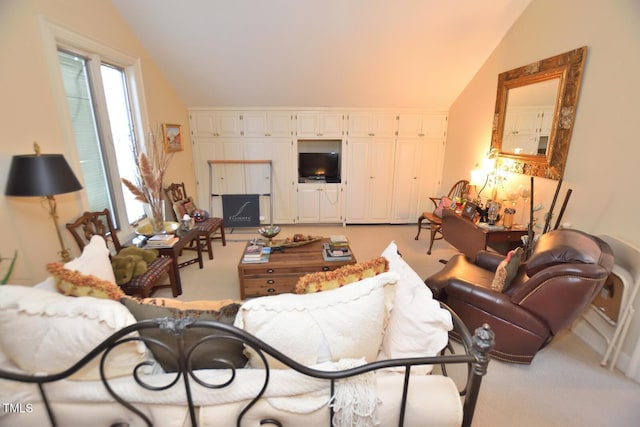 carpeted living room featuring lofted ceiling