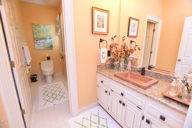 bathroom with tile patterned floors, vanity, and toilet