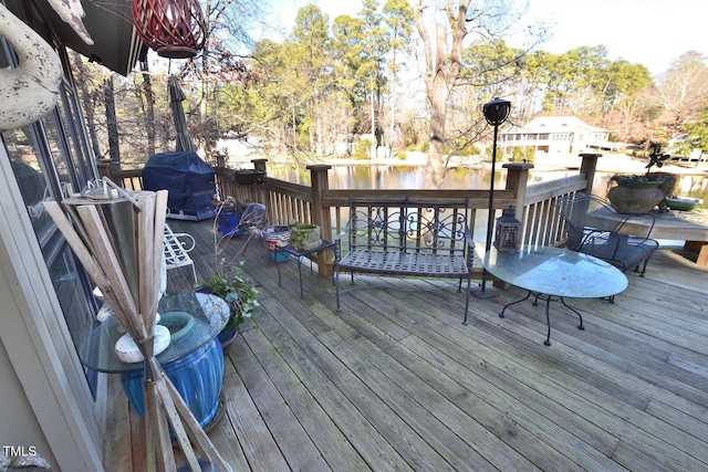 wooden terrace with a grill