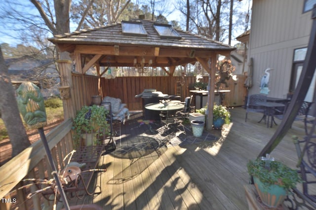 wooden terrace featuring a gazebo