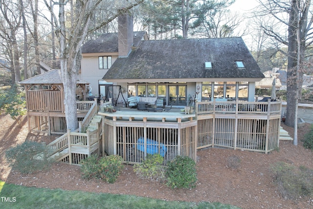 back of house featuring a deck