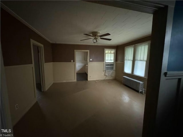 unfurnished room featuring ceiling fan, cooling unit, radiator heating unit, and ornamental molding