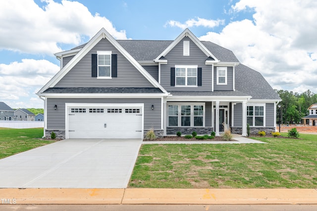 craftsman inspired home featuring a garage, concrete driveway, stone siding, and roof with shingles
